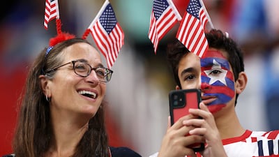 These fans wear their US pride with smiles on their faces. Getty