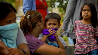 Relatives wait as rescuers search for survivors. Getty Images