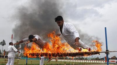 India's Central Reserve Police Force personnel perform a stunt during the passing out parade in Humhama, on the outskirts of Srinagar, India. Danish Ismail / Reuters