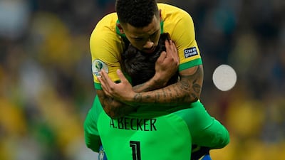 Brazil's Gabriel Jesus celebrates with goalkeeper Alisson after scoring his penalty to defeat Paraguay. AFP
