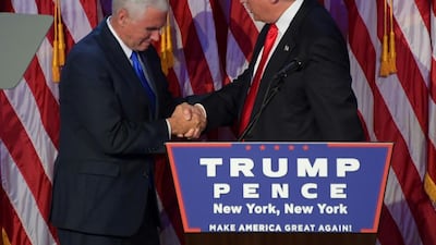 Republican president-elect Donald Trump, right, shakes hands with Republican candidate for Vice President Mike Pence on election night at the New York Hilton Midtown in New York. Jim Watson / AFP