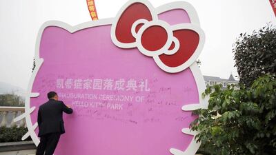 A man signs on a Hello Kitty cut-out during the inauguration ceremony of the Hello Kitty amusement park in Anji, Zhejiang province. Carlos Barria / Reuters
