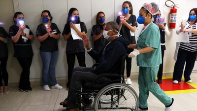 Health workers light their phones in his honour as Jose Queiroz dos Santos, 62, is discharged after surviving coronavirus disease at Parelheiros Municipal Hospital in Sao Paulo, Brazil. Reuters