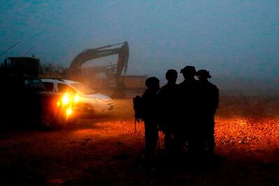 Israeli soldiers gather near excavation equipment at work on the border with Lebanon after the discovery of Hezbollah cross-border "attack tunnels". AFP