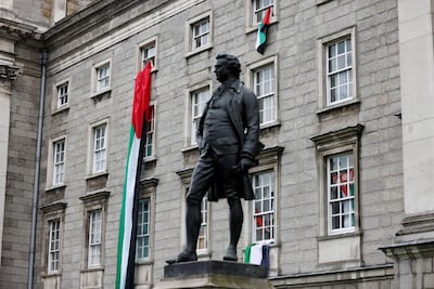 Palestinian flags hang on the front of the Trinity College. Reuters