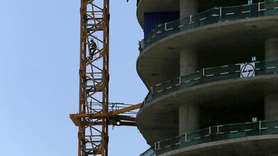 A worker climbs on a ladder at a construction site in Colombo. Reuters