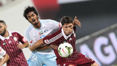 Al Wahda's Sebastian Taglibue, right, fights os a Baniyas challenge during their Arabian Gulf League match in Abu Dhbai on Thursday night. Mostafa Reda / Al Ittihad