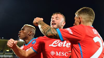 Amir Rrahmani celebrates with teammates after scoring the winning goal for Napoli against Fiorentina. AFP