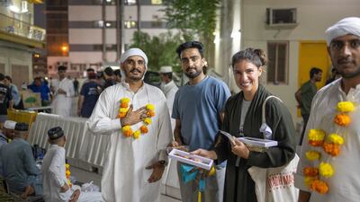 Ms Addas welcoming workers in Al Quoz Industrial area after they'd performed Umrah
