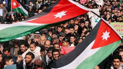 Demonstrators hold Jordanian national flag and chant slogans during a protest against a government's agreement to import natural gas from Israel, in Amman, Jordan. Reuters