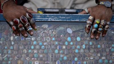 A vendor is shwon wearing his rings as he sells his merchandise in Kabul, Afghanistan. Farshad Usyan / AFP