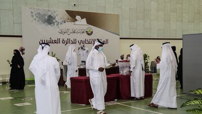 Qatari men cast their ballots at a polling station in Al Khor. AFP
