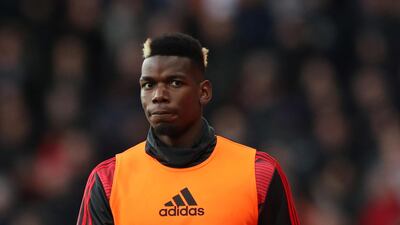 Manchester United's Paul Pogba wamrs up on the touchline. Reuters