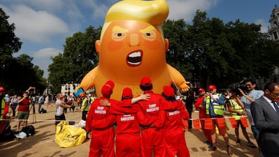 Demonstrators stand in front of the blimp at Parliament Square. Reuters