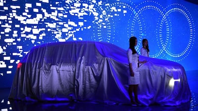 Models prepare to unveil an Audi Q7 e-tron car during a presentation at the 16th Shanghai International Automobile Industry Exhibition. Johannes Eisele / AFP