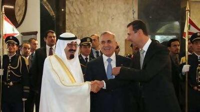 Saudi Arabia's King Abdullah, left, shakes hands with Syria's President Bashar al Assad as Lebanon's President Michel Suleiman smiles at the presidential palace in Baabda, near Beirut.