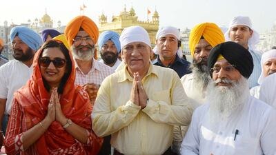 Gen Rawat, centre, and his wife Madhulika Rawat, left, seen paying their respects at the Golden Temple in Amritsar, in 2018. AFP