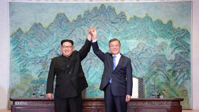 In this Friday, April 27 file photo, North Korean leader Kim Jong Un, left, and South Korean President Moon Jae-in raise their hands after signing on a joint statement at the border village of Panmunjom in the Demilitarised Zone, South Korea. Korea Summit Press Pool / AP