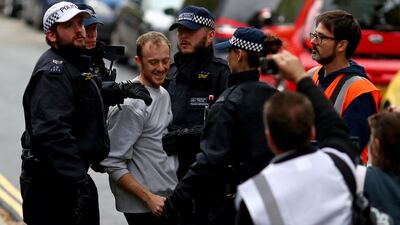 Police officers detain a man outside Lambeth County Court, during a raid on an Extinction Rebellion storage facility, in London, Britain October 5, 2019. REUTERS/Simon Dawson