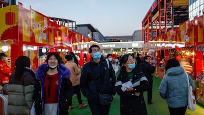People at a shopping district in Beijing. Growth in China is expected to increase to 5.2 per cent in 2023 from three per cent last year, according to the International Monetary Fund. EPA