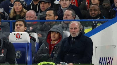 Alexis Sanchez, centre, watches on from the substitutes bench during Arsenal's League Cup semi-final first leg against Chelsea. John Sibley / Reuters