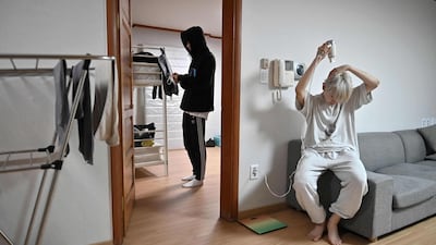 Blitzers member Lee Jun-young, right, drying his hair after getting up, at the band's shared house in Seoul. AFP