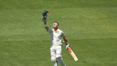 David Warner of Australia points to the sky after reaching his century on Day 1 of the first Test against India on Tuesday in Adelaide. Robert Cianflone / Getty Images / December 9, 2014