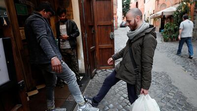 People salute using their feet to avoid contact, after movement was restricted across Italy. The world should keep calm and carry on with life. Reuters