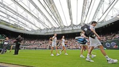 Wimbledon moves into the 21st century as Andre Agassi and Steffi Graf, Tim Henman and Kim Clijsters leave after their exhibition mixed doubles match to mark the launch of he new retractable roof over the Centre Court last month.