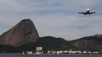 A Gol plane flies next to the Sugar Loaf mountain as it prepares to land at Santos Dumont airport in Rio de Janeiro, Brazil. The carrier reported profits that beat estimates. Sergio Moraes / Reuters