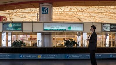 A driver with a name card waits to collect a passenger at baggage claim in Sharm El Sheikh airport.