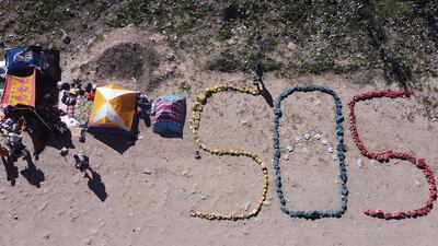 Venezuelan migrants made this SOS sign at their campsite near the border between Mexico and the US. EPA
