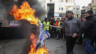 Palestinian protesters burn Israeli flags during a demonstration against US President Donald Trump's Middle East peace proposal in Khan Yunis in the southern Gaza Strip. AFP