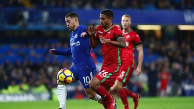 Chelsea forward Eden Hazard is challenged by Kyle Naughton. Clive Rose / Getty Images