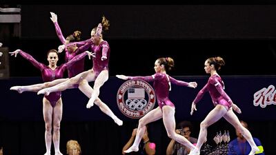 In this multiple exposure photo shot at one quarter of a second intervals, McKayla Maroney competes on the balance beam during the final round of the women's Olympic gymnastics trials, Sunday, July 1, 2012, in San Jose, Calif. Maroney was named to the U.S. Olympic gymnastics team. (AP Photo/Julie Jacobson)