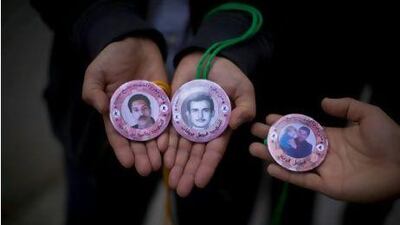 Rachid Ghannouchi's entourage hand out memorial medallions featuring images of An Nahda supporters who died in prison. Silvia Razgova / The National
