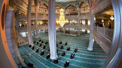 Mullahs wearing masks to help stop the spread of the coronavirus wait for Eid al-Adha prayer while maintaining a social distance at the main Mosque in Moscow, Russia, Friday, July 31, 2020. Eid al-Adha, or Feast of Sacrifice, Islam's most important holiday, marks the willingness of the Prophet Ibrahim to sacrifice his son. (AP Photo/Alexander Zemlianichenko)