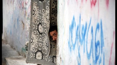 The US golfer Zach Johnson, centre, looks at a divot on the third green with Team Europe golfers Rory McIlroy, left, and Ian Poulter during the afternoon four-ball. Mike Blake / Reuters