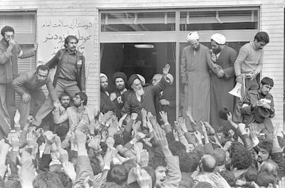 Ayatollah Khomeini, centre, waves to followers as he appears on the balcony of his headquarters in Tehran in 1979. Campion / AP Photo