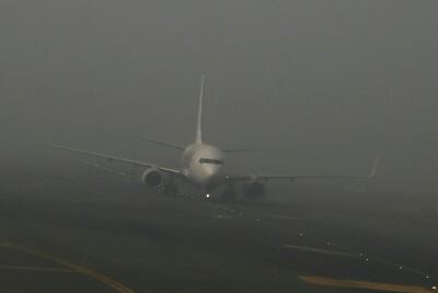 An aircraft prepares to take off in dense fog on a cold winter morning at Indira Gandhi International Airport in New Delhi in December 2023. AFP