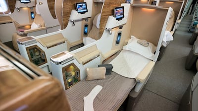 The business-class cabin has lie-flat seats and a personal minibar, but no sliding doors. Photo: Emirates