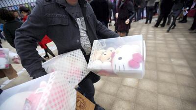 A man carries Hello Kitty toys during the inauguration ceremony of the first Hello Kitty amusement park outside Japan. The 150-acre theme park is expected to attract one million visitors each year. Carlos Barria / Reuters