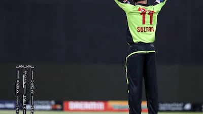 Qalandars' Sultan Ahmad celebrates taking the wicket of Arabians' Chris Lynn. Chris Whiteoak / The National