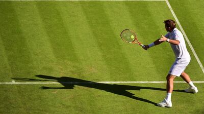 Stan Wawrinka returns against Joao Sousa during his first round victory on Monday at the opening day of the 2015 Wimbledon championship. Leon Neal / AFP