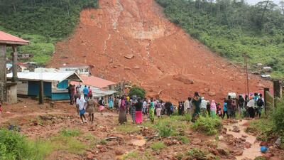 People inspecting the damage after a mudslide in the mountain town of Regent, Sierra Leone on August 14, 2017. Ernest Henry / Reuters
