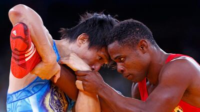Cuba's Yowlys Bonne Rodriguez (in red) fights with Japan's Kenichi Yumoto on the Men's 60Kg Freestyle wrestling at ExCel. Grigory Dukor/Reuters