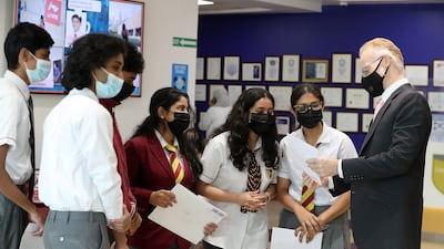 Pupils discuss their A-level results with Lachlan MacKinnon, principal at Cambridge International School in Dubai. Pawan Singh / The National
