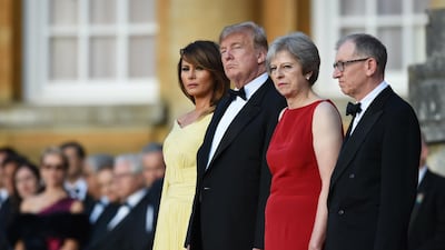 Britain's Prime Minister Theresa May and her husband Philip May greet US President Donald Trump and First Lady Melania Trump at Blenheim Palace on July 12, 2018 in Woodstock, England. Getty Images