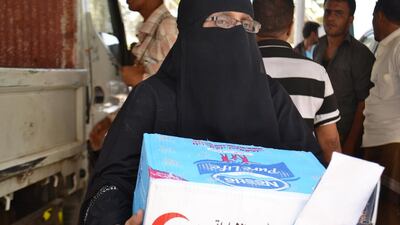 Zainab Abdullah carries home an aid package from the Emirates Red Crescent in Aden on August 21, 2015. Mohammed Ahmed Al Qalisi for The National
