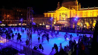 People skate on an outdoor ice rink during the Christmas market in Zagreb, Croatia. EPA